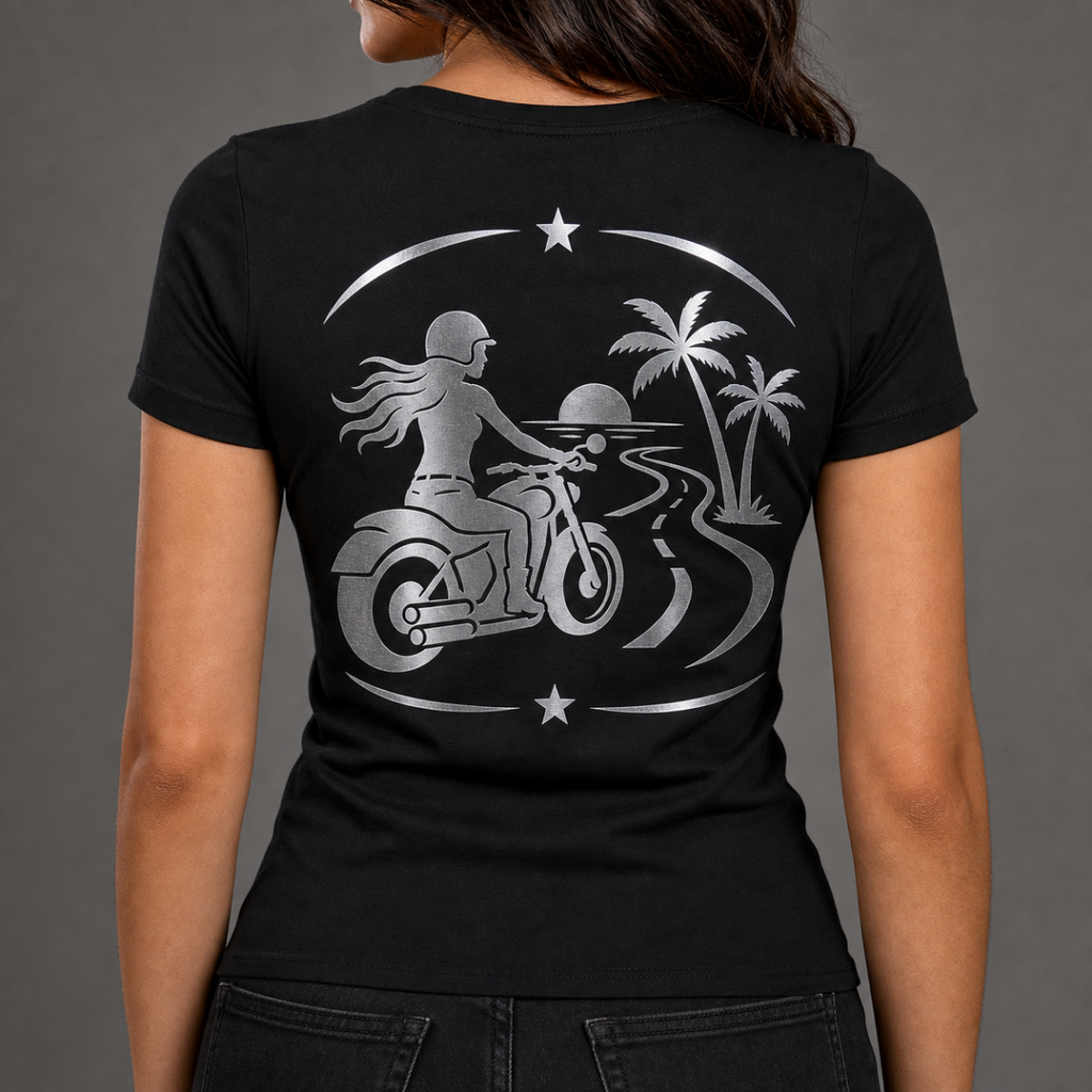Endless Miles reflective women's motorcycle V-neck tee - back view showing woman rider on coastal road with palm trees and sunset reflective vinyl design